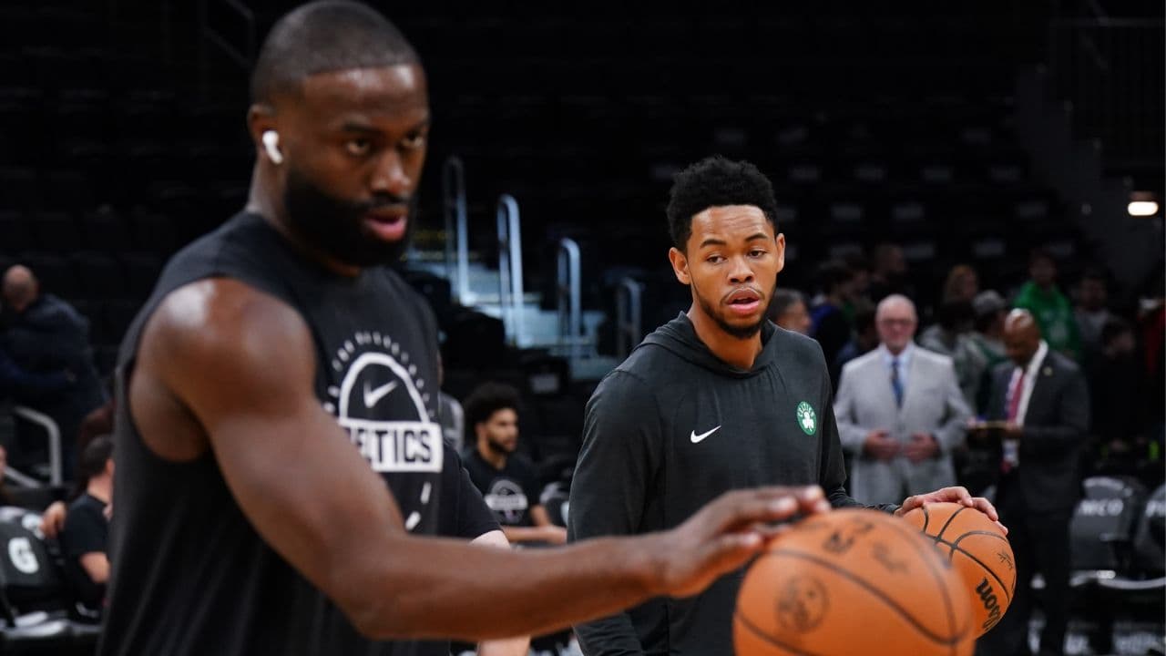 Boston Celtics guard Anfernee Simons (4) and guard/forward Jaylen Brown (7) warm up before the start of the game against the Washington Wizards at TD Garden.
