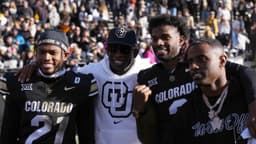 Colorado Buffaloes safety Shilo Sanders (21) and head coach Deion Sanders and quarterback Shedeur Sanders (2) and social media producer Deion Sanders Jr. following the win against the Oklahoma State Cowboys at Folsom Field.