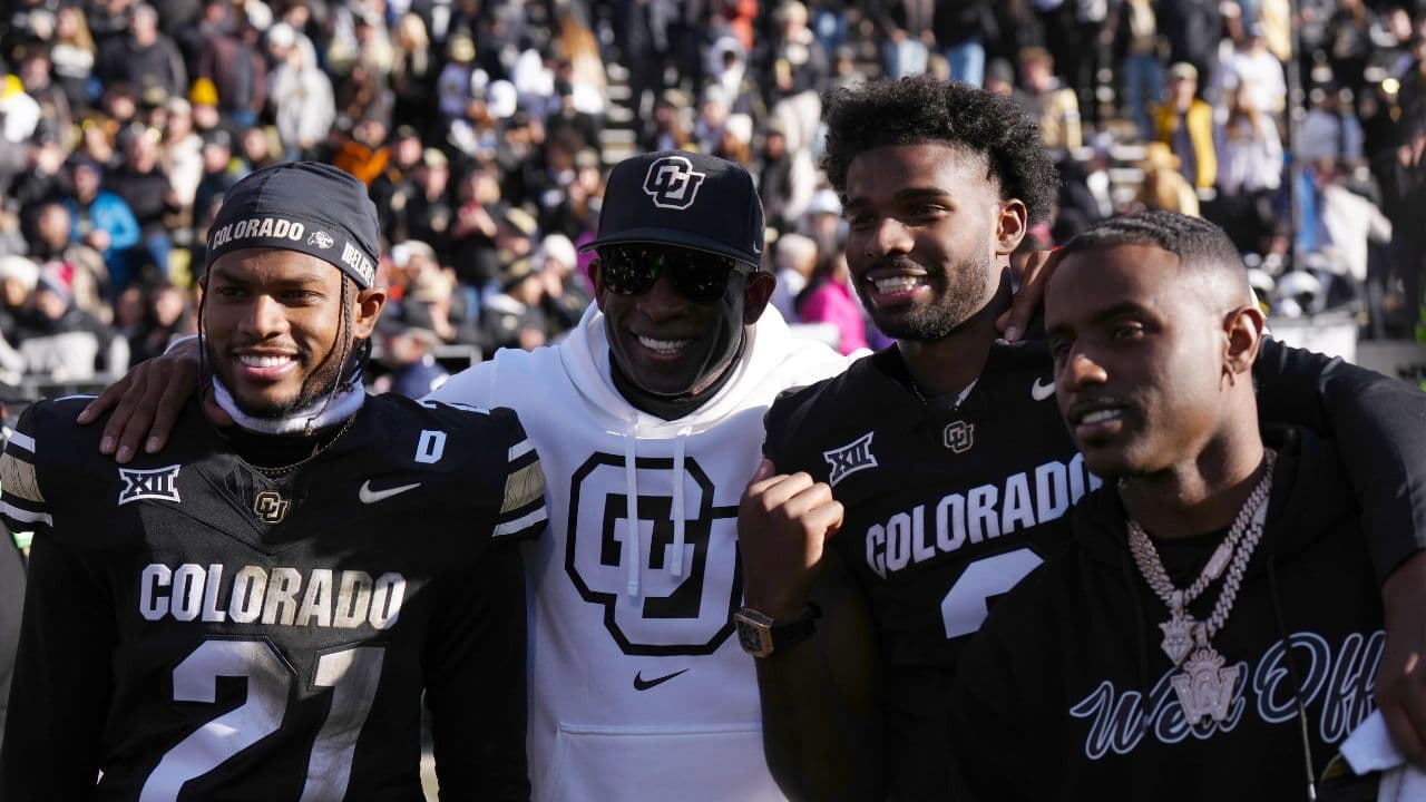 Colorado Buffaloes safety Shilo Sanders (21) and head coach Deion Sanders and quarterback Shedeur Sanders (2) and social media producer Deion Sanders Jr. following the win against the Oklahoma State Cowboys at Folsom Field.