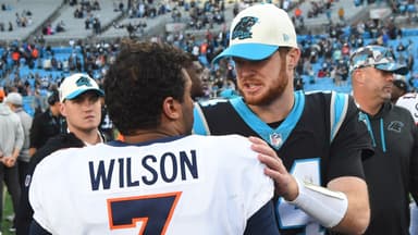 Carolina Panthers quarterback Sam Darnold (14) with Denver Broncos quarterback Russell Wilson (3) after the game at Bank of America Stadium.