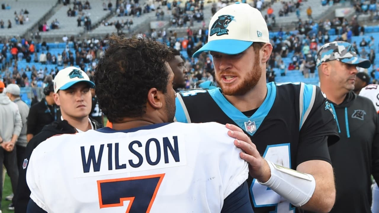 Carolina Panthers quarterback Sam Darnold (14) with Denver Broncos quarterback Russell Wilson (3) after the game at Bank of America Stadium.