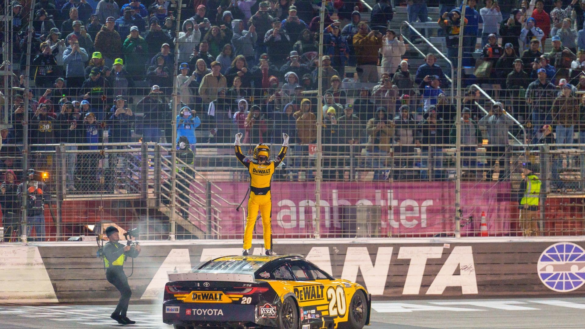 hristopher Bell (20) does his celebratory waves at the crowd after claiming a victory at Atlanta Motor Speedway.