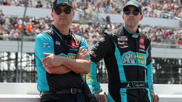 Jul 14, 2024; Long Pond, Pennsylvania, USA; NASCAR Cup Series driver Denny Hamlin (right) stands with his crew chief Chris Gabehart (left) on pit road prior to The Great American Getaway 400 at Pocono Raceway.
