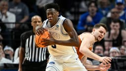 BYU Cougars forward AJ Dybantsa (3) keeps the ball from Texas Longhorns forward Camden Heide (5) in the second half during a first round game of the men's 2026 NCAA Tournament at Moda Center.