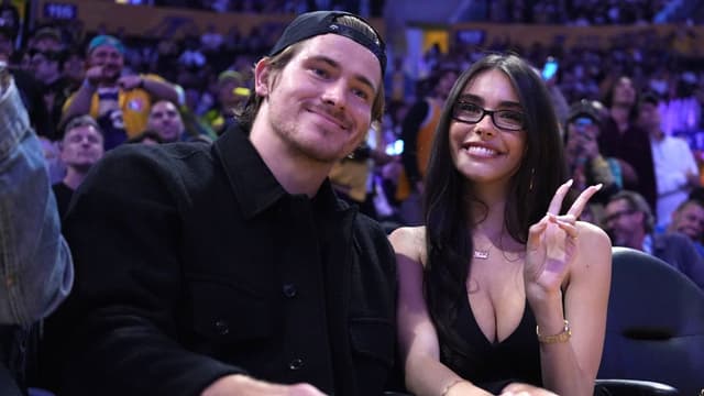 Los Angeles Chargers quarterback Justin Herbert (left) and girlfriend Madison Beer attend the game between the Minnesota Timberwolves and the Los Angeles Lakers at Crypto.com Arena.