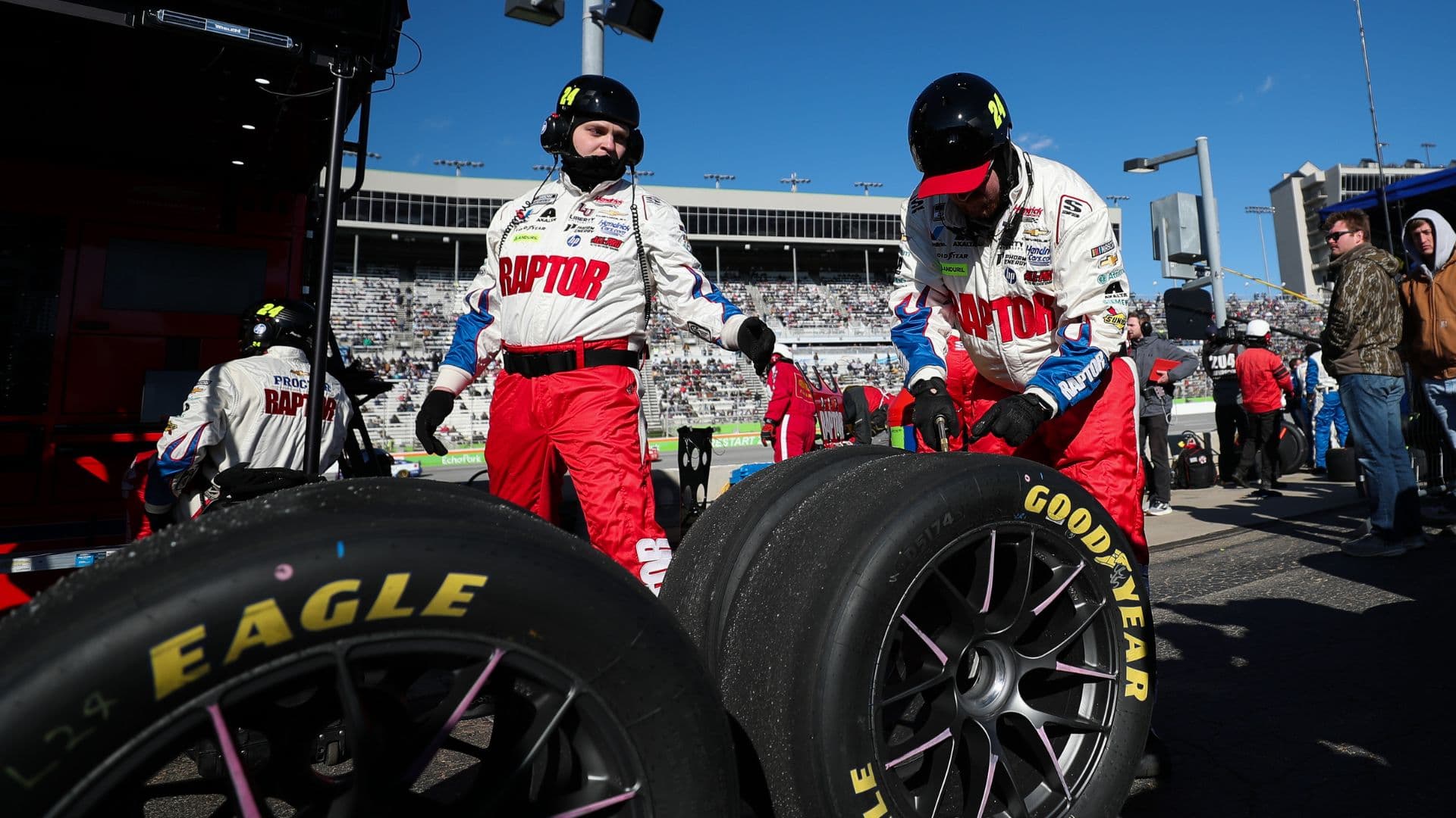 Feb 22, 2026; Hampton, Georgia, USA; Raptor team members work on the tires at EchoPark Speedway.