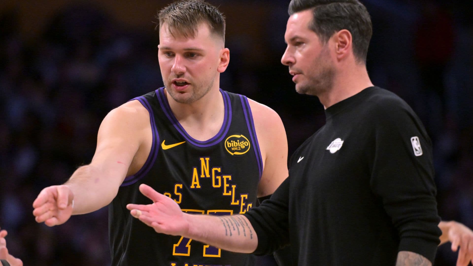 Jan 2, 2026; Los Angeles, California, USA; Los Angeles Lakers guard Luka Doncic (77) talks with head coach JJ Redick during a time out in the second half against the Memphis Grizzlies at Crypto.com Arena