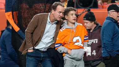 Former Denver Broncos player Peyton Manning with his son Marshall before the game against the Cleveland Browns at Empower Field at Mile High.