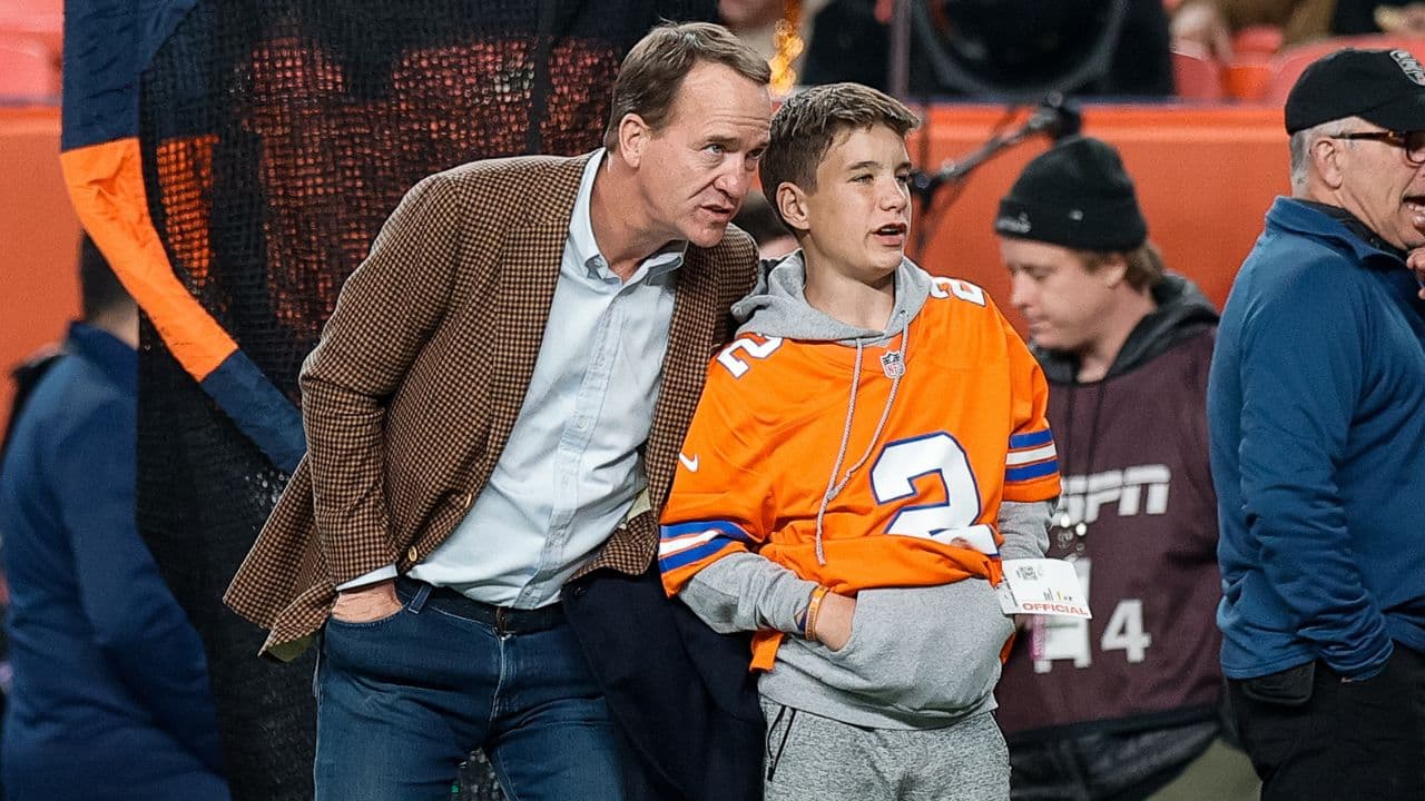 Former Denver Broncos player Peyton Manning with his son Marshall before the game against the Cleveland Browns at Empower Field at Mile High.