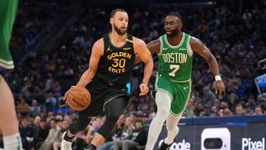 Golden State Warriors guard Stephen Curry (30) dribbles past Boston Celtics forward Jaylen Brown (7) in the third quarter at the Chase Center.