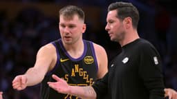Los Angeles Lakers guard Luka Doncic (77) talks with head coach JJ Redick during a time out in the second half against the Memphis Grizzlies at Crypto.com Arena