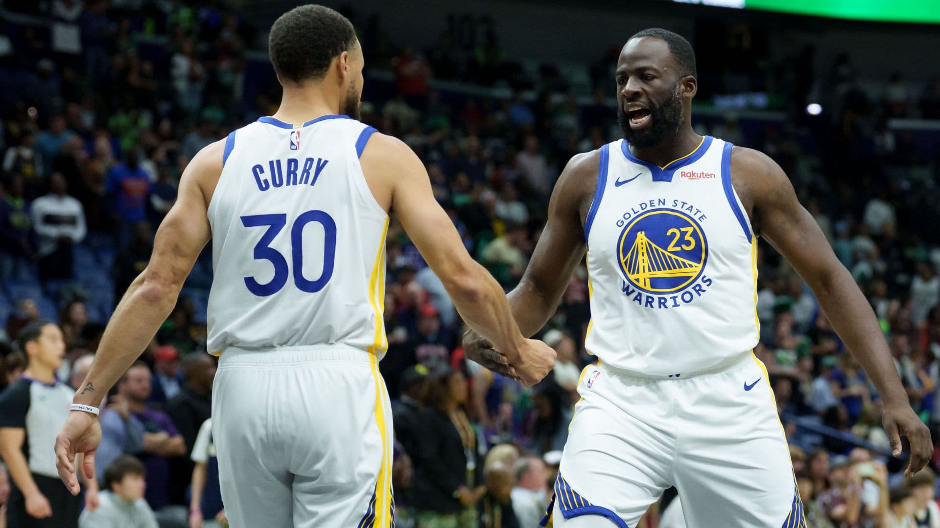 Nov 16, 2025; New Orleans, Louisiana, USA; Golden State Warriors forward Draymond Green (23) celebrates with guard Stephen Curry (30) during the first half against the New Orleans Pelicans at Smoothie King Center
