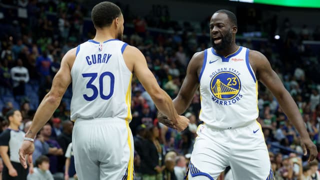 Nov 16, 2025; New Orleans, Louisiana, USA; Golden State Warriors forward Draymond Green (23) celebrates with guard Stephen Curry (30) during the first half against the New Orleans Pelicans at Smoothie King Center