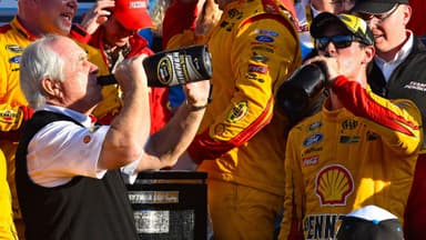 Feb 22, 2015; Daytona Beach, FL, USA; NASCAR Sprint Cup Series driver Joey Logano (22) celebrates with team owner Roger Penske in victory lane after winning the Daytona 500 at Daytona International Speedway