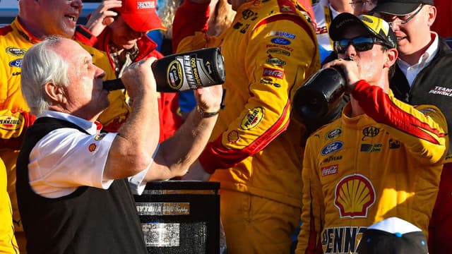 Feb 22, 2015; Daytona Beach, FL, USA; NASCAR Sprint Cup Series driver Joey Logano (22) celebrates with team owner Roger Penske in victory lane after winning the Daytona 500 at Daytona International Speedway