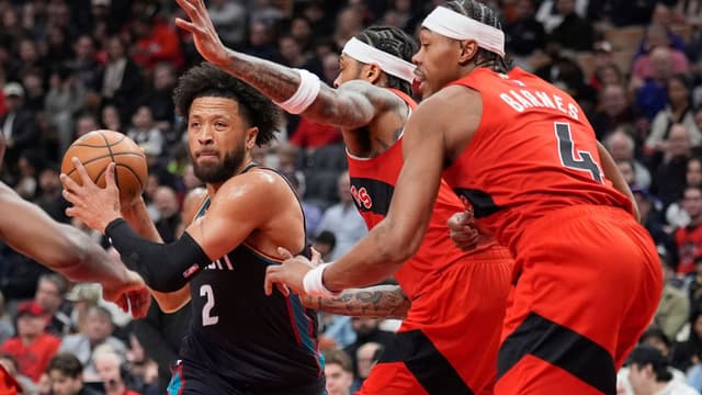 Mar 15, 2026; Toronto, Ontario, CAN; Detroit Pistons guard Cade Cunningham (2) tries to get off a shot against Toronto Raptors forward RJ Barrett (9) and guard Scottie Barnes (4) during the first half at Scotiabank Arena.