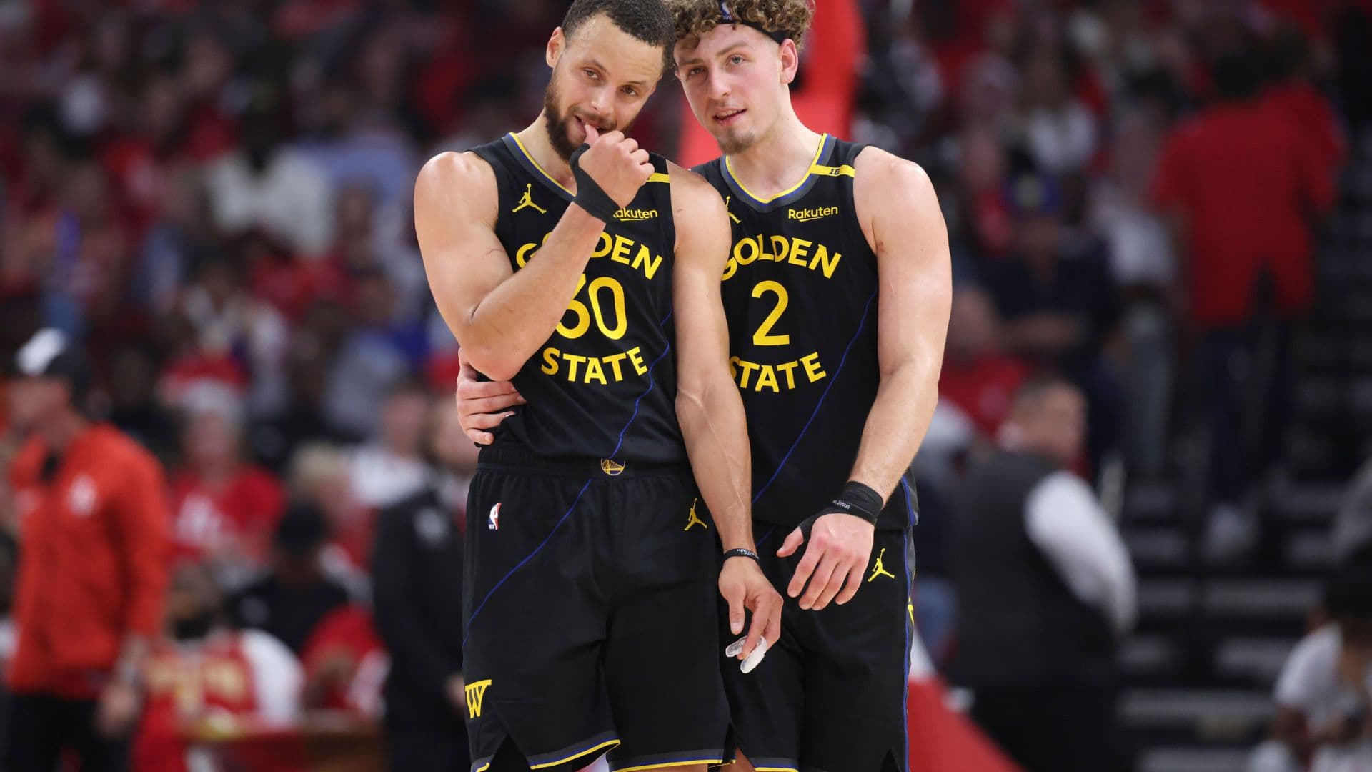 May 4, 2025; Houston, Texas, USA; Golden State Warriors guard Stephen Curry (30) and guard Brandin Podziemski (2) talk during a timeout during game seven of first round for the 2025 NBA Playoffs against the Houston Rockets at Toyota Center