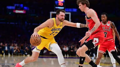 Los Angeles Lakers guard Luka Doncic (77) moves the ball against Chicago Bulls forward Matas Buzelis (14) during the first half at Crypto.com Arena.