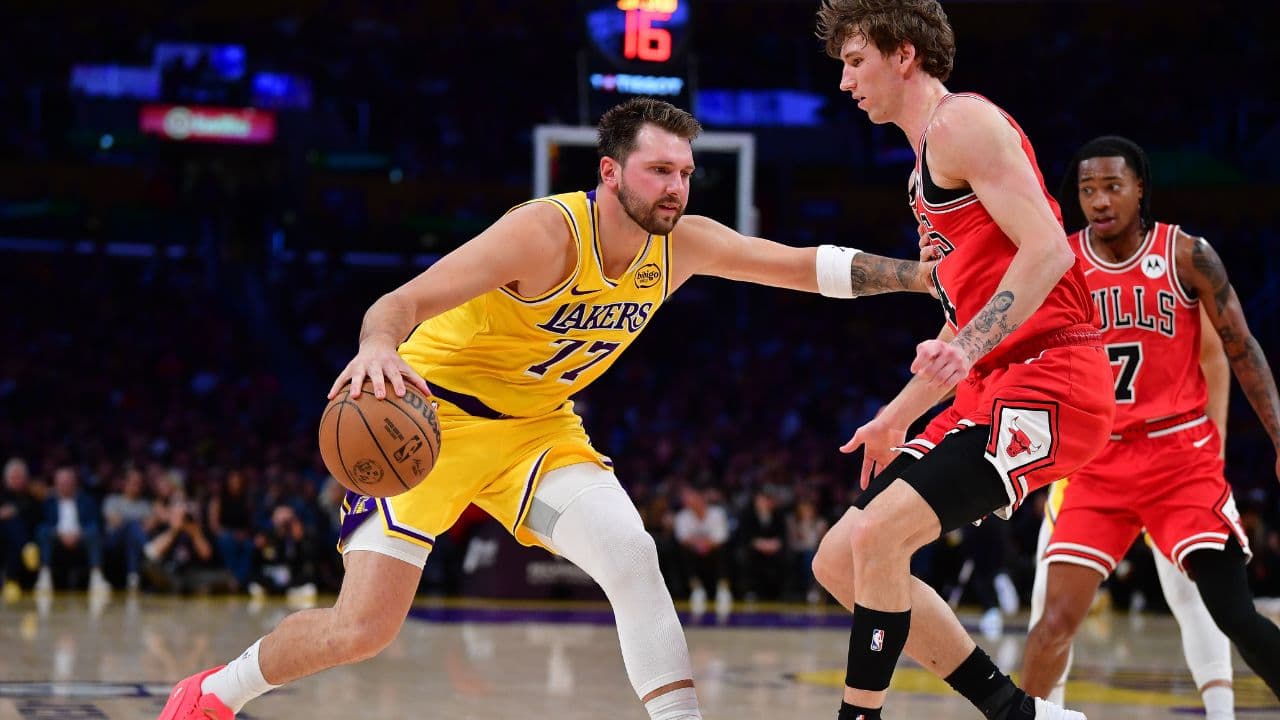 Los Angeles Lakers guard Luka Doncic (77) moves the ball against Chicago Bulls forward Matas Buzelis (14) during the first half at Crypto.com Arena.