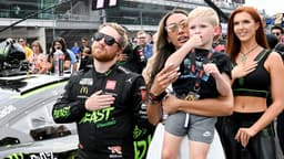 NASCAR Cup Series driver Tyler Reddick (45) stands with his wife, Alexa De Leon, and son, Beau, during the national anthem ahead of the Brickyard 400, Sunday, July 21, 2024, at Indianapolis Motor Speedway.