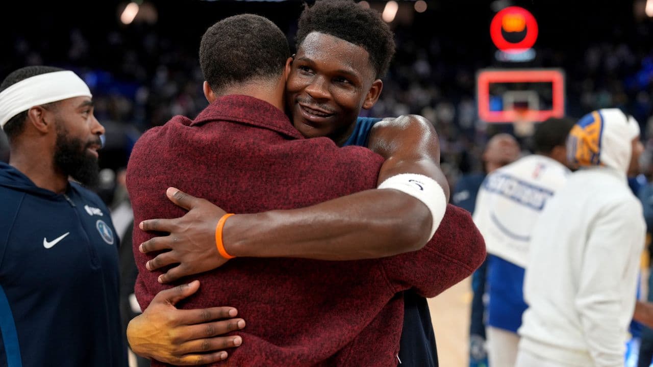 Minnesota Timberwolves guard Anthony Edwards (5) hugs Golden State Warriors guard Stephen Curry (30) after the game at the Chase Center.