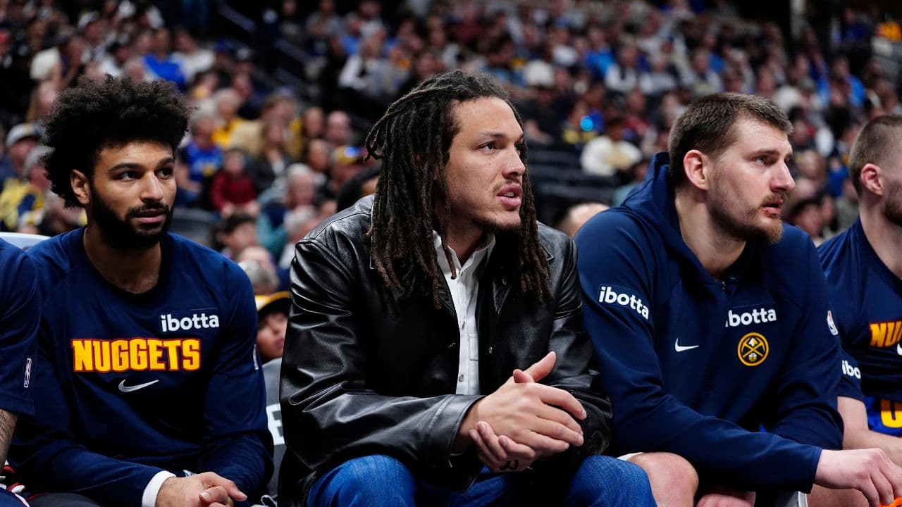 Mar 1, 2026; Denver, Colorado, USA; Denver Nuggets guard Jamal Murray (27) and forward Aaron Gordon (32) and center Nikola Jokic (15) on the bench during the second quarter against the Minnesota Timberwolves at Ball Arena. Mandatory Credit: Ron Chenoy-Imagn Images