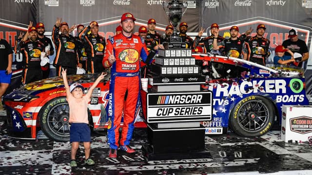 Aug 31, 2025; Darlington, South Carolina, USA; NASCAR Cup Series driver Chase Briscoe (19) celebrates his win with his son Brooks at the Cookouts Southern 500 at Darlington Raceway.