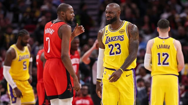 Houston Rockets forward Kevin Durant (7) talks with Los Angeles Lakers forward LeBron James (23) on the court during the second quarter at Toyota Center.