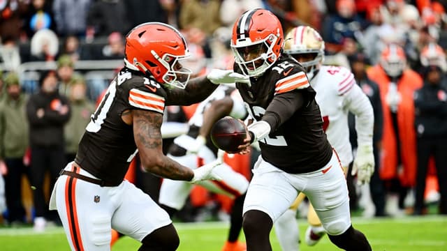 Cleveland Browns quarterback Shedeur Sanders (12) hands off the ball to Cleveland Browns running back Quinshon Judkins (10) during the first half against the San Francisco 49ers at Huntington Bank Field.