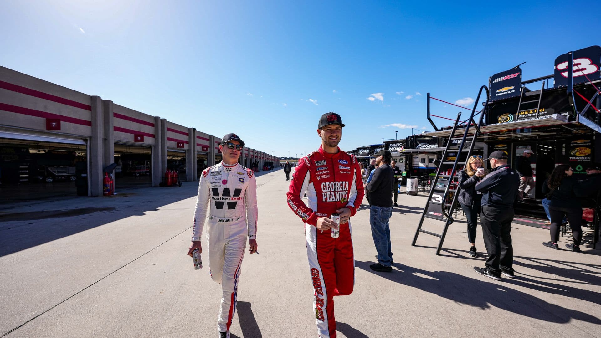 Feb 25, 2024; Hampton, Georgia, USA; NASCAR Cup Series driver Zane Smith (71) and NASCAR Cup Series driver Todd Gilliland (38) walks through the garage prior to qualifying for the Ambetter Health 400 at Atlanta Motor Speedway.