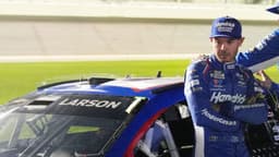 Kyle Larson waits by his car before the NASCAR Cup Series Duel during Speedweek, Thursday, Feb. 12, 2026.