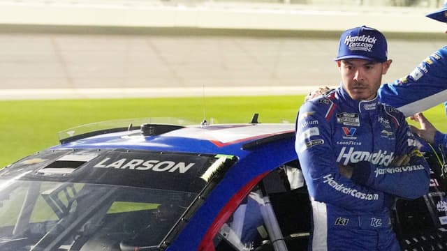 Kyle Larson waits by his car before the NASCAR Cup Series Duel during Speedweek, Thursday, Feb. 12, 2026.