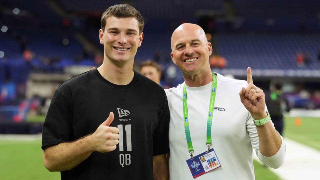 Indiana quarterback Fernando Mendoza (QB11) poses with former Seattle Seahawks quarterback Matt Hasselbeck during the NFL Scouting Combine at Lucas Oil Stadium.